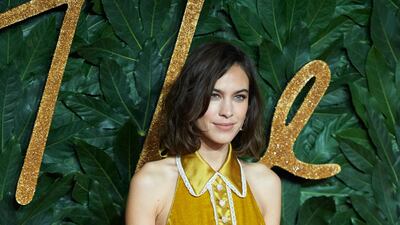 British model Alexa Chung dons a dress in mustard velvet. EPA