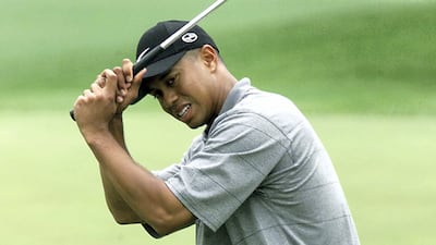 Tiger Woods after missing a birdie putt on the 8th hole during the opening round. AFP