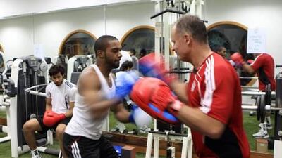 led Eissa, Al Jazira’s No 1, centre, works the pads with goalkeeping coach David Coles as Khaled al Sinani watches.