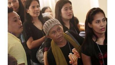 Filipino relatives of victims of the Maguindanao massacre listen before the start of the hearing at a maximum security prison in Taguig, south of Manila, yesterday. Francis R Malasig / EPA