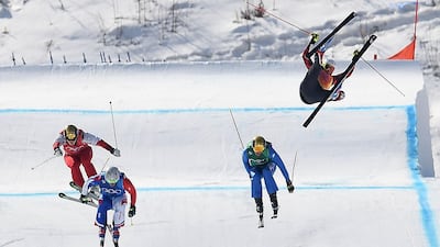 Canada's Christopher Delbosco, right, falls as France's Francois Place, second left. leads the men's ski cross quarter-final heat. Loic Venance / AFP Photo