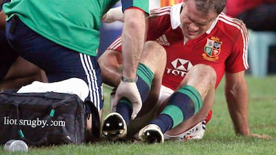 Roberts sits on the sideline being assisted by team trainers after being injured. David Gray / Reuters