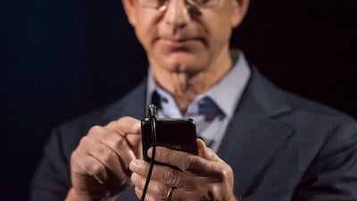 Jeff Bezos demonstrates Amazon's first smartphone, the Fire Phone, in Seattle in June 2014. Getty Images
