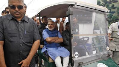 Hindu nationalist Narendra Modi, prime ministerial candidate for India's main opposition Bharatiya Janata Party and Gujarat's chief minister, sits in a golf car at a business conclave organised by Muslim businessmen of Gujarat state, in the western Indian city of Ahmedabad on Friday. Amit Dave / Reuters