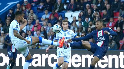 PSG's Kylian Mbappe challenges for the ball with Auxerre's Jubal and Paul Joly. AP