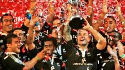 New Zealand's captain DJ Forbes holds the trophy aloft as he celebrates with teammates after beating Fiji 31-21 in last year's final in Dubai.