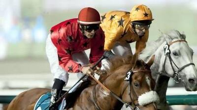 Dubai, United Arab Emirates, March 1 2012, Meydan Racecourse Twelfth Carnival Meeting - (left Red silks) #3 AVERROES ridden by Micro Demuro and trained by Ernst Oertel and back Yellow silks) ELECTROLYSER ridden by Ted Duncan and Trained by Clive Cox sit along the rail as they pass the Grandstands for the first time in the 2810m Turf Classic at Meydan Racecourse March 1 2012. Mike Young / The National??