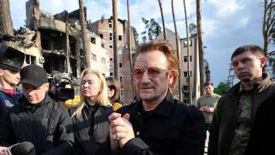 Bono greets people in Irpin. AFP