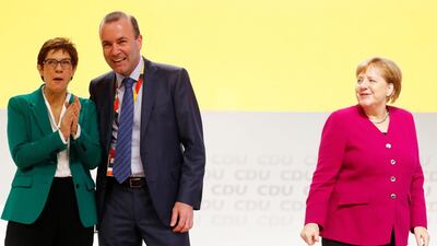 Newly elected CDU leader Annegret Kramp-Karrenbauer with Manfred Weber of the Bavarian sister party CSU (Christian Social Union) and German Chancellor Angela Merkel, during the CDU party congress in Hamburg. Kai Pfaffenbach / Reuters