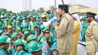 Lt Col Sultan Al Jammal, of the Human Trafficking unit at Dubai Police’s Department of Human Rights, addresses the workers. Courtesy Dubai Police