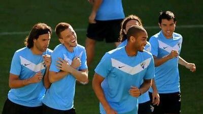 Malaga's players share a light moment in training at the Rosaleda stadium.