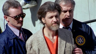 Ted Kaczynski, better known as the Unabomber, is escorted from a courthouse by US federal agents in 1996. AP