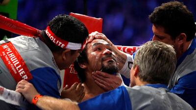 Manny Pacquiao of the Philippines is treated in his corner between rounds during his welterweight fight against Juan Manuel Marquez. Steve Marcus / Reuters