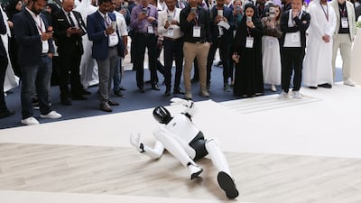 A robot begins to stand up for a flat position, as part of a demonstration at the Make it in the Emirates event in Abu Dhabi. Chris Whiteoak / The National