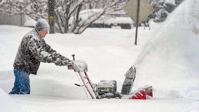 Darrell Chesley clears the snow from his driveway in Wellsville, Utah. The Herald Journal / AP