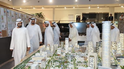 Sheikh Mohammed bin Rashid and some senior Dubai Holding officials view a scaled version of the Jumeirah Central project. WAM