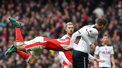 Arsenal’s Shkodran Mustafi dives through the air against Spurs’ Vincent Janssen. Ben Stansall / AFP
