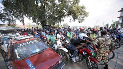 Motorists wait in a queue to fill petrol for their vehicles in Kathmandu. Navesh Chitrakar / Reuters