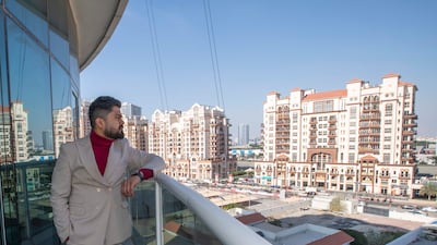 Mr Hunda enjoys the view from his balcony