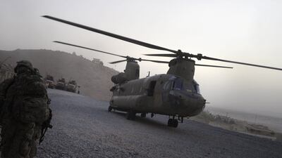 In this photograph taken on July 29, 2011 a US military Chinook helicopter lands at Forward Operating Base in Arghandab district southern Afghanistan. Thirty-one US special forces and seven Afghans died when the Taliban shot down their helicopter, officials said on August 6, 2011, the deadliest incident yet for foreign troops in a decade-long war. All were killed during an anti-Taliban operation late Friday when a rocket fired by the insurgents struck their Chinook helicopter in Wardak province, southwest of the capital Kabul, as they prepared to leave after a firefight. AFP PHOTO / ROMEO GACAD *** Local Caption *** 563901-01-08.jpg