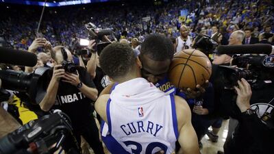 Golden State Warriors’ Stephen Curry, front, is hugged by teammate Draymond Green after a 125-104 win over the Memphis Grizzlies during an NBA basketball game Wednesday, April 13, 2016, in Oakland, California. (AP Photo/Marcio Jose Sanchez)