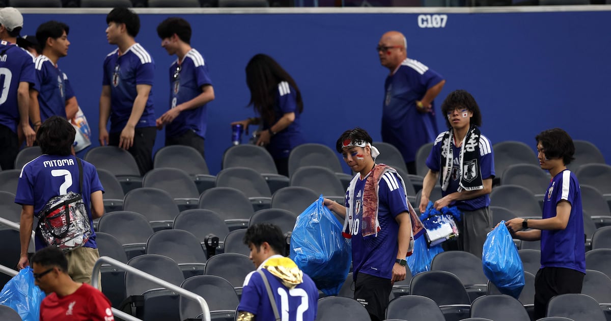 Why do Japan fans and players clean the stadium after a match?