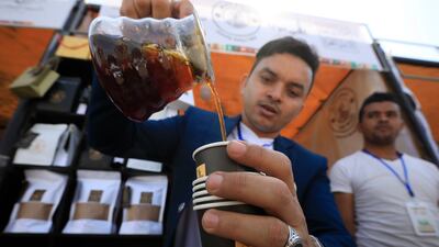 A barista serves Arabica coffee during an event in Sanaa. EPA
