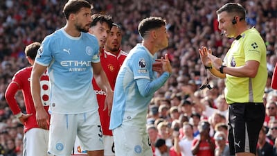 City's Phil Foden remonstrates with referee Michael Oliver after being shown a red card. Reuters