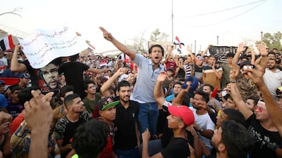 People shout slogans during a protest near the main provincial government building in Basra. Reuters