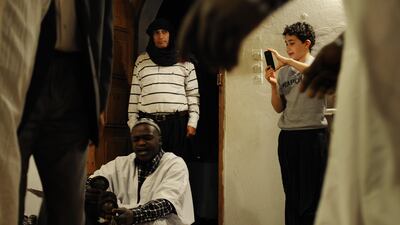 Sophian Tamar, (right), the son of a French-Algerian tourist couple, takes a photograph during a music performance at the Maison Traditionelle Akham in Guardaia. Lindsay Mackenzie for The National.