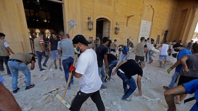 People clean debris at Mohammed Al Amin mosque in the centre of Beirut. AFP