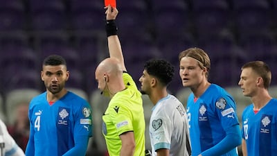 Israel's Roy Revivo receives a red card from referee Anthony Taylor. AP