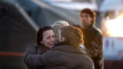 A woman reacts following an earthquake aftershock, at a makeshift camp in L'Aquila, central Italy.