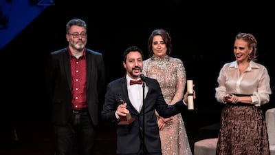 Tunisian director Mehdi Barsaoui receives the award for Best Arabic Film for 'A Son' during the closing ceremony of the 41st Cairo International Film Festival. AFP