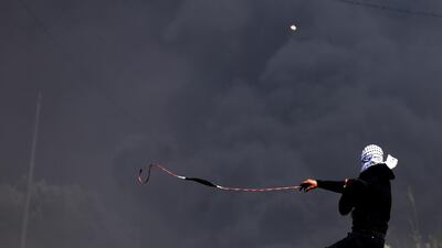 Palestinian protester uses his sling shot to throw stones at Israeli soldiers during a demonstration against Israel's settlements in the village of Kofr Qadom near the northern West Bank city of Nablus. EPA