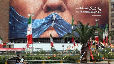 A billboard featuring US President Donald Trump and the Strait of Hormuz, on Valiasr Square in Tehran. AFP