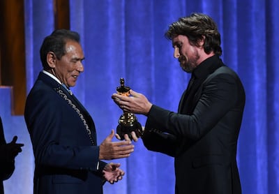 Christian Bale presents Wes Studi with his honorary award at the Governors Award. AFP