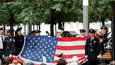 A US flag that few over the World Trade Center is presented during the ceremonies in New York. Reuters