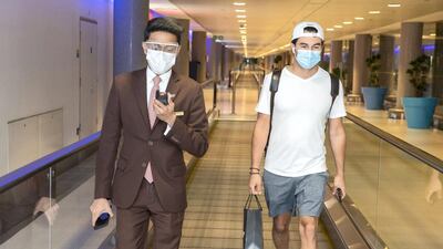 Sakhir Grand Prix winner Sergio Perez is accompanied by Etihad Airways staff at Abu Dhabi Airport.