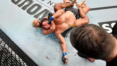 Deiveson Figueiredo, left, of Brazil secures a rear choke submission against Joseph Benavidez. Getty Images