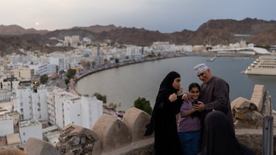 People enjoy the sunset at Mutrah Fort in Muscat, Oman. Reuters