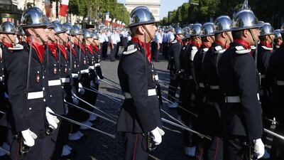 Members of the Ecole Nationale Superieure des Officiers de Sapeurs-Pompiers, or the French firefighters' elite school, march in order Geoffrey van der Hasselt / AFP Photo