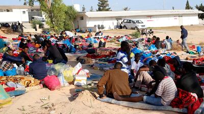Migrants are seen with their belongings in the yard of a detention centre hit by an air strike in the Tajoura suburb of Tripoli, Libya. Reuters