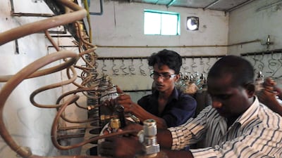 Workers examine oxygen cylinders at the Baba Raghav Das Hospital in Gorakhpur, in the northern Indian state of Uttar Pradesh, on August 12, 2017, after the recent deaths of dozens of child patients was blamed on a lack of oxygen supply. AFP