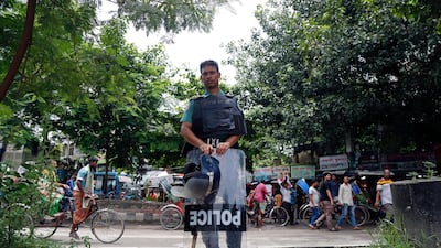 A Bangladeshi policeman on duty stand at a roadside in the Shahbag area of Dhaka, Bangladesh. EPA / MONIRUL ALAM