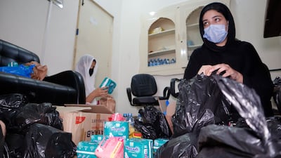 Aymen Naseem, a psychologist working with Da Hawwa Lur, preparing sanitary kits for those affected by Pakistan's record flooding. Tariq Ullah for The National