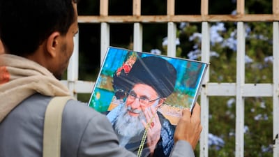 A Houthi supporter holds a portrait of Iran's supreme leader Ayatollah Ali Khamenei in Yemen's capital Sanaa. EPA