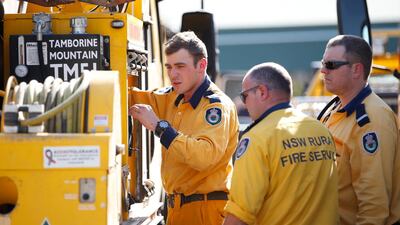 Fire and Emergency crew from New South Wales prepare to join on going bushfire control efforts near the rural town of Canungra in Queensland, Australia. EPA