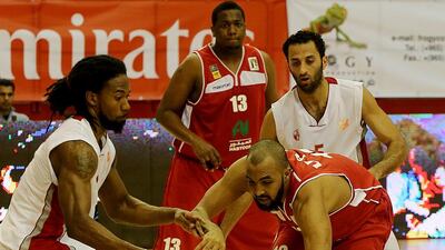 UAE's Qais Omar, 12, chases the ball against Al Ahly of Libya. Khaled Khalifa of UAE, 13, looks on. Satish Kumar / The National