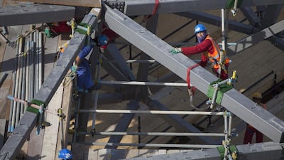 Work on the last super-sized element is lifted into its place in the puzzle of the Louvre Abu Dhabi dome. Silvia Razgova / The National